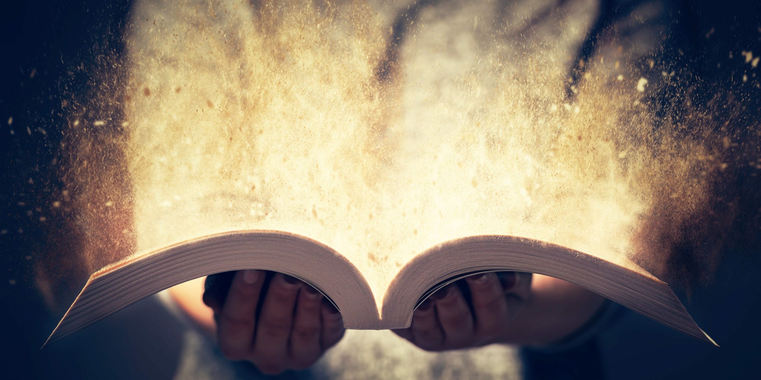 Woman holding an open book with two hands. Light coming out of the book as a concept of learning, education, knowledge and religion