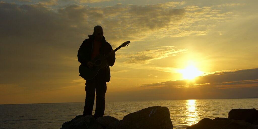 lonely guitarist on the evening beach and sundown https://www.thesoulmedic.com/wp-content/uploads/./iStock-160108290-scaled.jpg